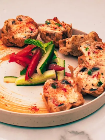 A beautifully plated appetizer, showcasing our attention to detail. Each component is carefully arranged to create a visually stunning and delicious dish.