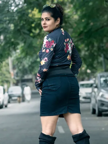 A back view of the floral top and mini-skirt look, showing how it creates a strong and confident silhouette.