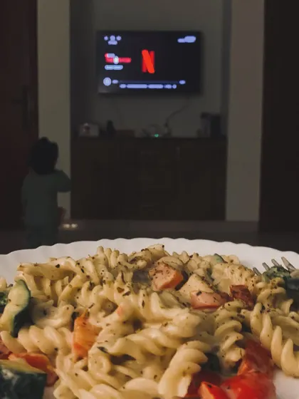 A plate of pasta and Netflix after the baby is asleep. Balance is key, and enjoying your favorite foods in moderation is part of a healthy lifestyle.
