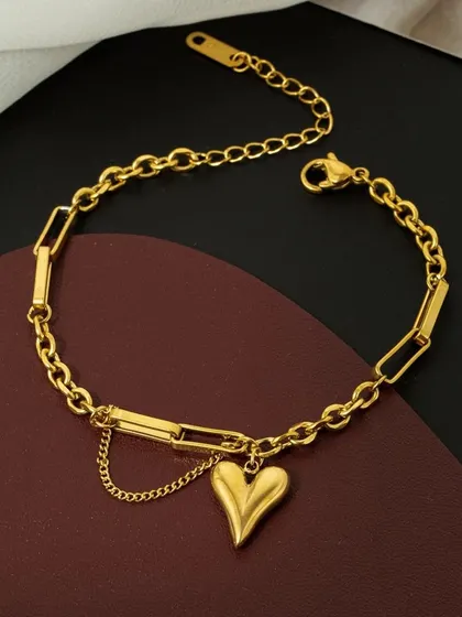 A trendy paperclip chain bracelet featuring a puffy heart charm and a delicate secondary chain. This piece is made from high-quality stainless steel.