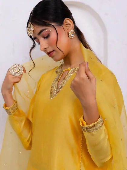 A festive look I styled for A.Projekt, featuring a vibrant yellow salwar suit. The creative direction focused on a clean, minimalist backdrop with pops of yellow flowers to complement the outfit.