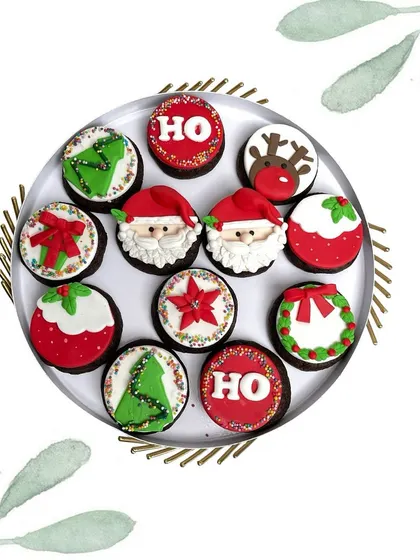 A dozen of our festive cupcakes, each with a unique Christmas design like Santa, a reindeer, or a wreath. Perfect for office parties.