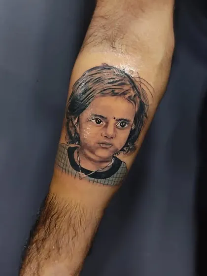 Creating a realistic portrait of a loved one is a responsibility I take very seriously. This tattoo of a client's child was done with great attention to detail to capture her likeness and create a lasting tribute.