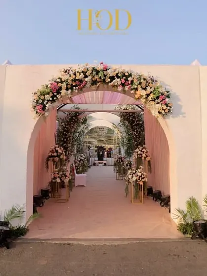 For this outdoor wedding, I designed a series of grand arches adorned with cherry blossom-inspired art and lush florals. The design creates a beautiful, layered effect that guides guests into the main event space with elegance and charm.