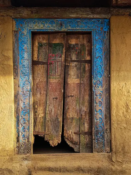 An old, decaying door with a beautifully carved blue frame, discovered in a small village. This image is from my project "The Doors of Maharashtra," where I explore how these structures tell stories of time and history.