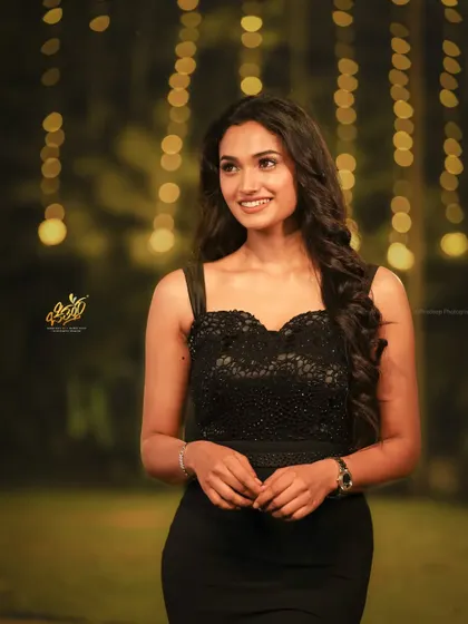 Actress Reeshma Nanaiah captured in a classic portrait pose at an evening awards event. The bokeh effect from the lights adds a touch of glamour to the photo.