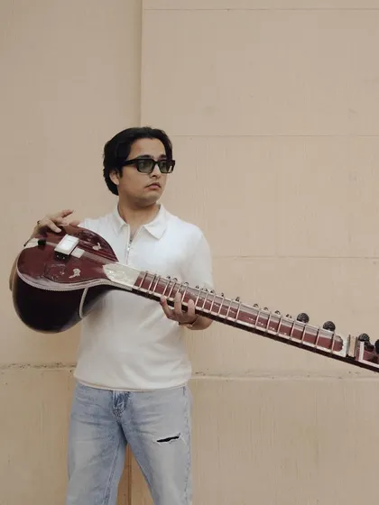 Holding my sitar. This instrument is more than just wood and strings; it is an extension of my voice and soul.