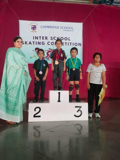 We celebrate every victory, big and small. Here, our talented young skaters stand proudly on the podium after winning medals at an inter-school skating competition, a testament to their hard work and our dedicated coaching.