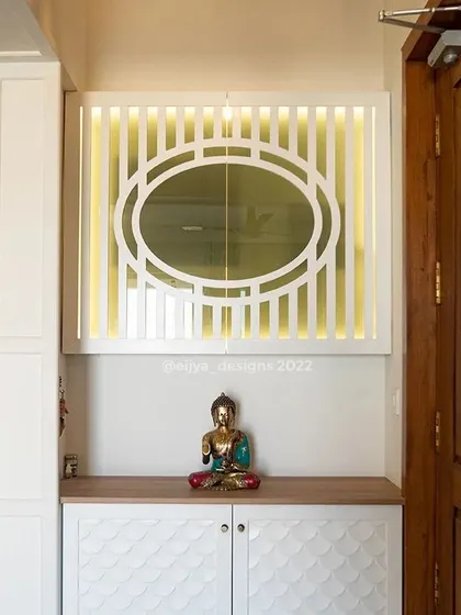 I transformed this entrance into a calming, zen-like space. The design features a shoe cabinet with a unique fish-scale pattern on the shutters and a backlit panel with a geometric design, creating a warm and welcoming first impression.