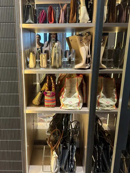 This image captures how we use vertical space to store a large handbag collection, with larger totes on top and smaller bags arranged below.