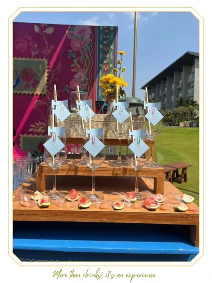 A beautiful mocktail bar setup for a sunny outdoor brunch, with pre-garnished glasses ready for service.