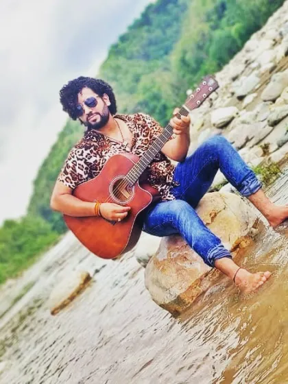 Finding inspiration with my guitar by the river. As a coach, I help you find your own inspiration and express your unique artistic voice, whether you are a beginner or an experienced singer.