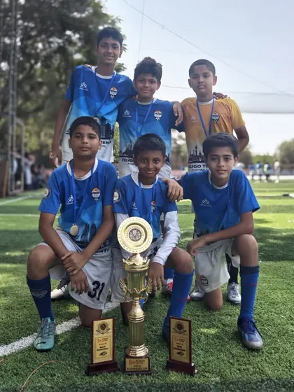 Another one of our winning youth teams celebrating their victory with their trophies.