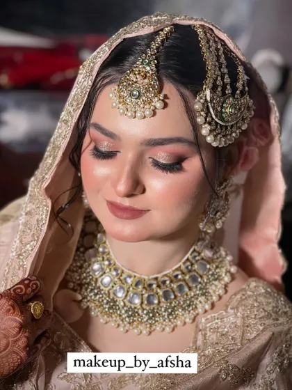 The dupatta setting is crucial for a Nikkah look. Here it is perfectly placed over her head.