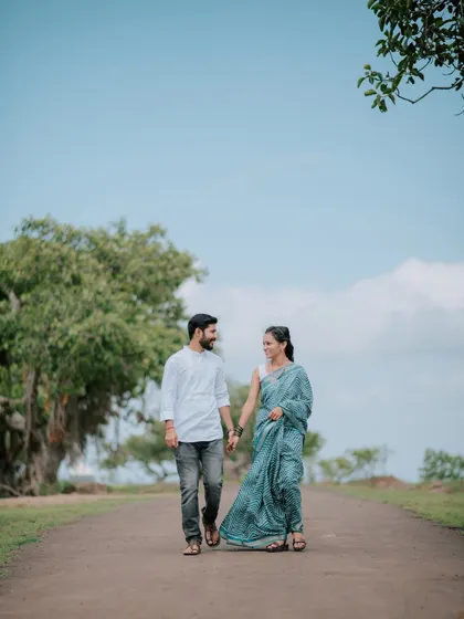 A couple takes a leisurely stroll down a country road for their pre-wedding photoshoot.