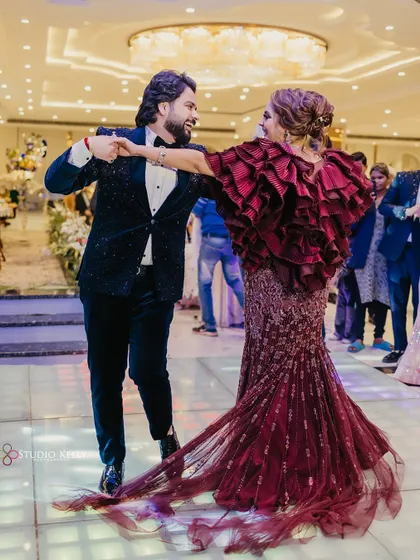 The couple shares a dance at their engagement party, the bride's ruffled gown creating beautiful movement.