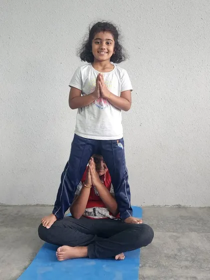 Another joyful example of our seated partner pose, a favorite for building confidence and camaraderie.