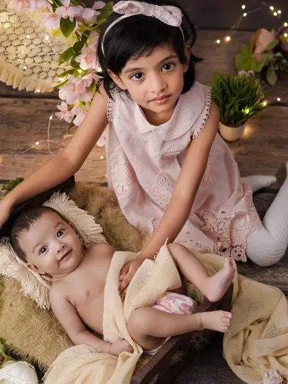 A moment of shared joy. I love seeing the happiness on a big sister's face as she gets to be part of her new sibling's first photoshoot.