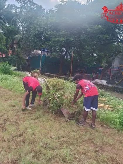 Our grounds team clearing the outfield. This unseen hard work is the foundation of our outdoor training sessions.