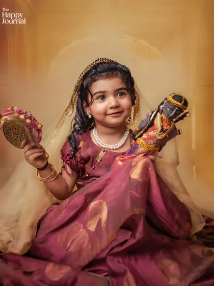 A little princess holding a traditional Indian puppet. This portrait is rich in color, culture, and storytelling.