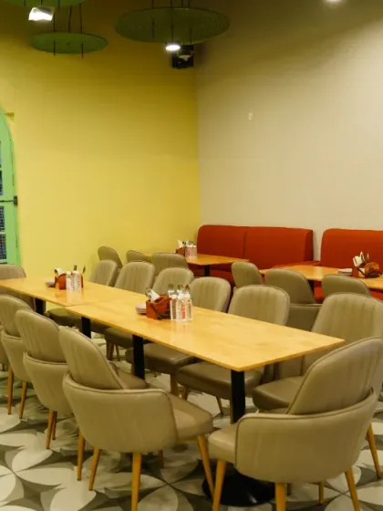 The clean and inviting dining area, ready to serve families. The long tables are great for larger groups or parties.