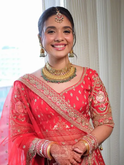 A minimal yet glossy look for this beautiful bride in red. I kept the focus on her glowing skin and bright smile, proving that a red bridal look can be both regal and refreshingly simple.