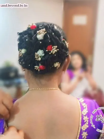 For a touch of romance, I adorned this textured messy updo with delicate artificial flowers in red, white, and gold. This style adds a whimsical and feminine touch, ideal for a bridesmaid or wedding guest.