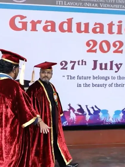 Walking onto the stage for the Graduation Day 2024 event. The banner quotes, "The future belongs to those who believe in the beauty of their dreams."