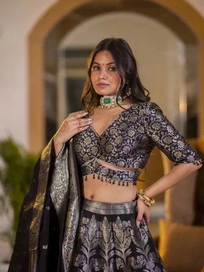 A closer shot of the Banarasi lehenga, focusing on the detailed blouse and the model's jewelry. This helps highlight how the outfit can be styled for a wedding or special occasion.