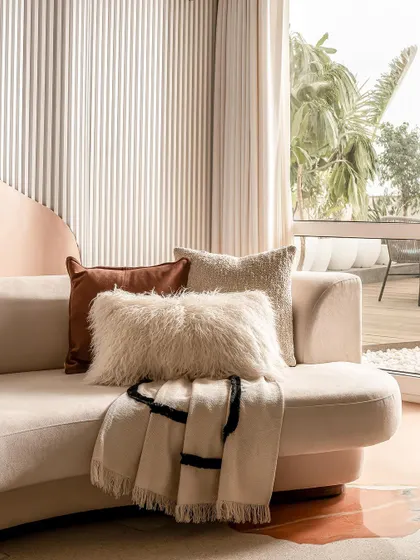 A close-up of the plush, textured fabrics used on the living room sofa, adding to the home's cozy and comfortable feel.