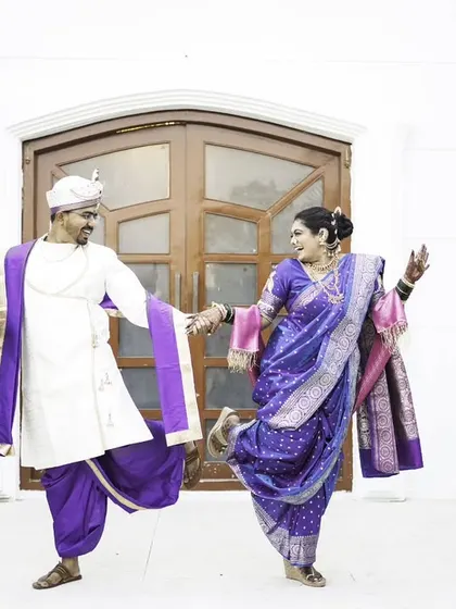 A fun and energetic dance pose, capturing the couple's joyful and playful spirit.