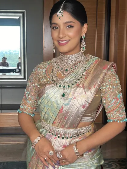 Unveiling a timeless beauty, this bride shines with grace and glamour in her pastel green saree and stunning diamond jewellery.