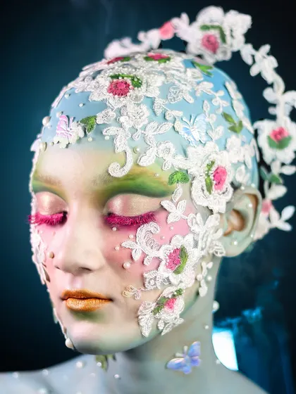 An eyes-closed shot that highlights the texture and artistry of the lace and floral details.