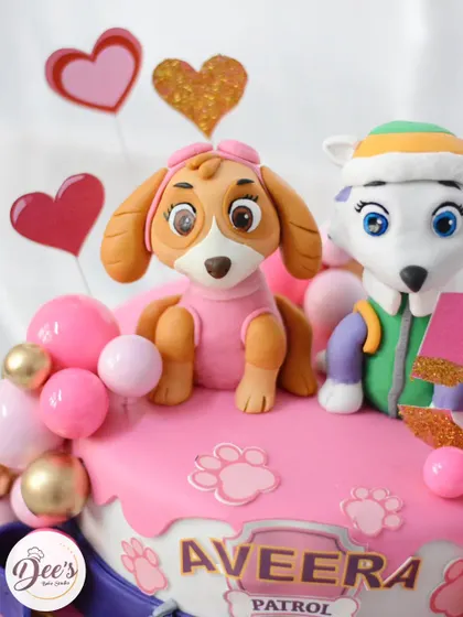 For the Paw Patrol fans, this cake features Skye and Everest. The design is full of pinks, purples, and fun details like paw prints and a collar belt.