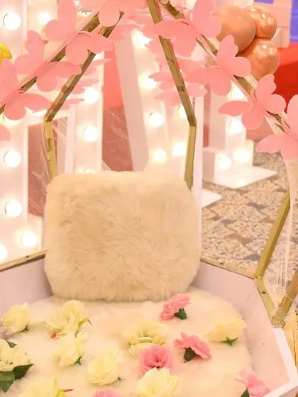 A detailed shot of a special seat for the birthday girl, decorated with small pink paper butterflies. This highlights our attention to every small detail in our themed party setups.