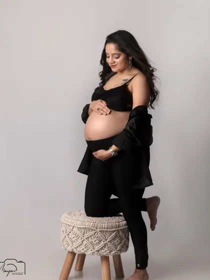 A powerful and graceful pose, highlighting the beauty of the pregnant form.