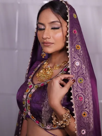 Makeup that enhances, not hides. This traditional bridal look in purple features a radiant base and perfectly sculpted eyes for effortless elegance.