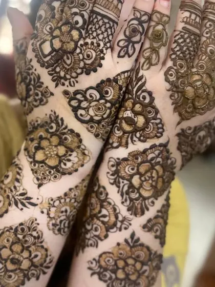 A designer pattern featuring floral motifs set within diamond shapes, creating a beautiful quilt-like effect.