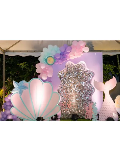 A close-up of the giant, iridescent seashell prop, a centerpiece of our mermaid party decor.