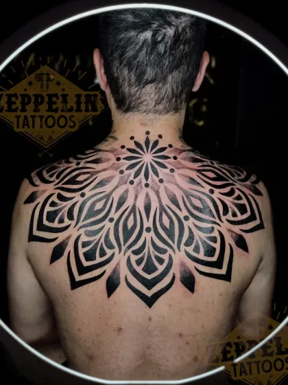 Large back pieces are a journey, and this finished geometric mandala is a testament to that process. I designed this to fit the client's entire upper back, using bold, solid blackwork to create a powerful and balanced piece that symbolizes harmony and wholeness.