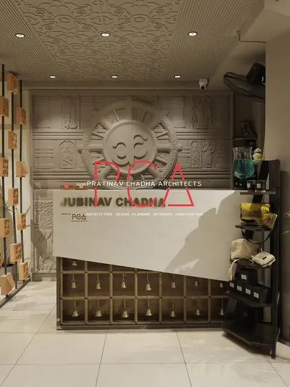 The front reception desk at the Jubinav Chadha studio, showcasing the brand name and the unique design elements that define the space.