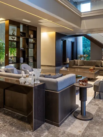 In this large farmhouse living area, our minimalist furniture pieces are arranged to create a sense of balance and flow. The custom sofas and tables stand out while maintaining a cohesive and functional design.