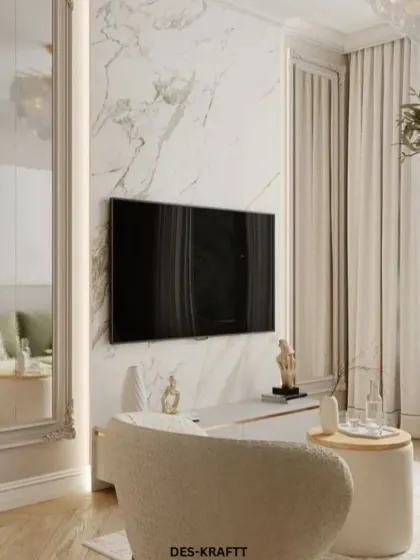 The entertainment area is designed with minimalism in mind, featuring a marble accent wall and a large mirror that enhances the sense of space and light.