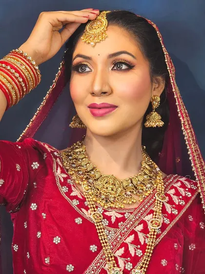 A beautiful shot of the bride, showcasing the harmony between her makeup, jewelry, and outfit. The warm tones in the makeup complement the gold jewelry perfectly.