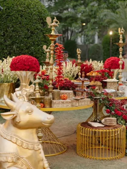 A lavish spread of traditional Indian sweets and snacks, beautifully arranged amidst red florals and golden Nandi statues. We believe that even food presentation should be an integral part of the overall design.