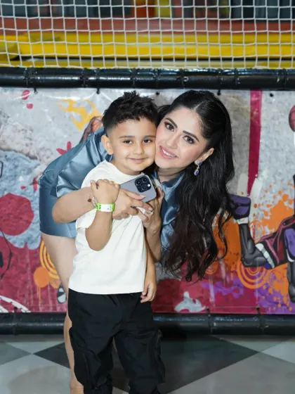 A sweet hug between a mother and her son against the backdrop of our colorful play area.