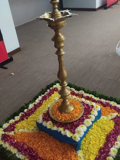 Another view of the floral rangoli and traditional lamp setup. We use fresh flower petals to create these beautiful and auspicious arrangements for event inaugurations.