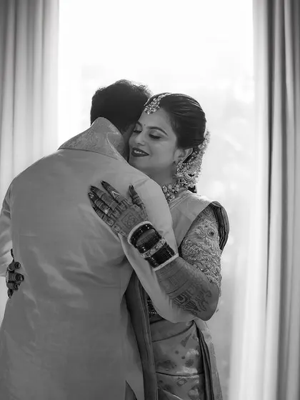 A heartfelt hug captured in timeless black and white. The focus is purely on the emotion of the moment, a simple and powerful expression of their bond.