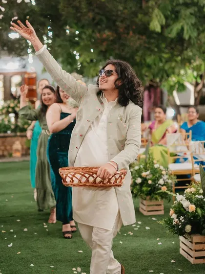 A 'flower boy' joyfully scattering petals down the aisle.