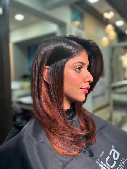 A sleek, straight style with a pop of coppery red at the ends. This is a great way to add a touch of color without going for an all-over look.